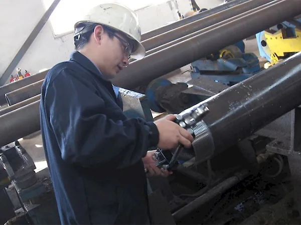 The worker is testing API casing pipe.