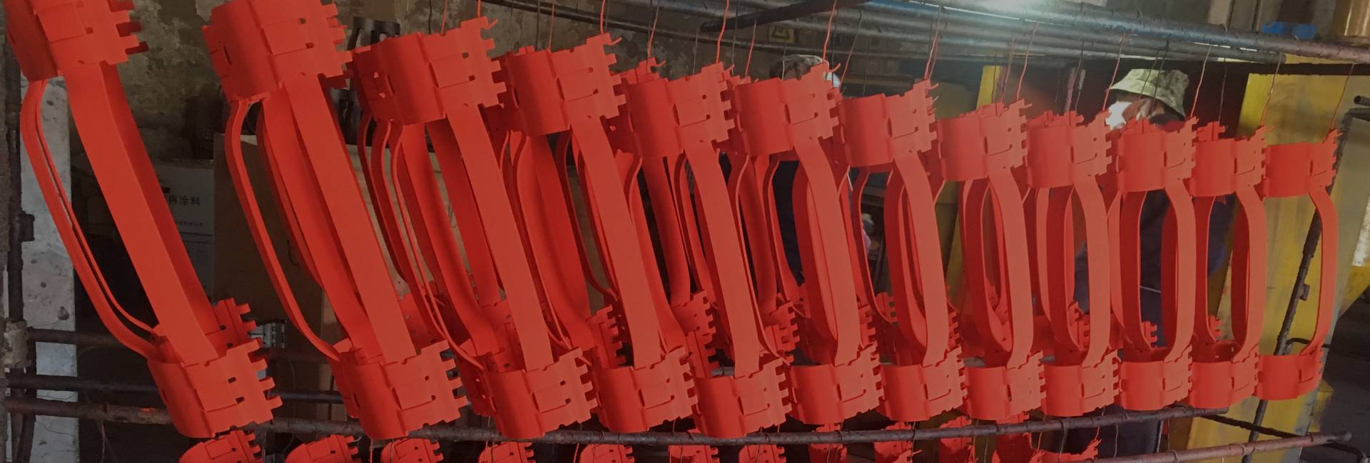 Several pieces of cementing casing centralizers are coated with powder coating