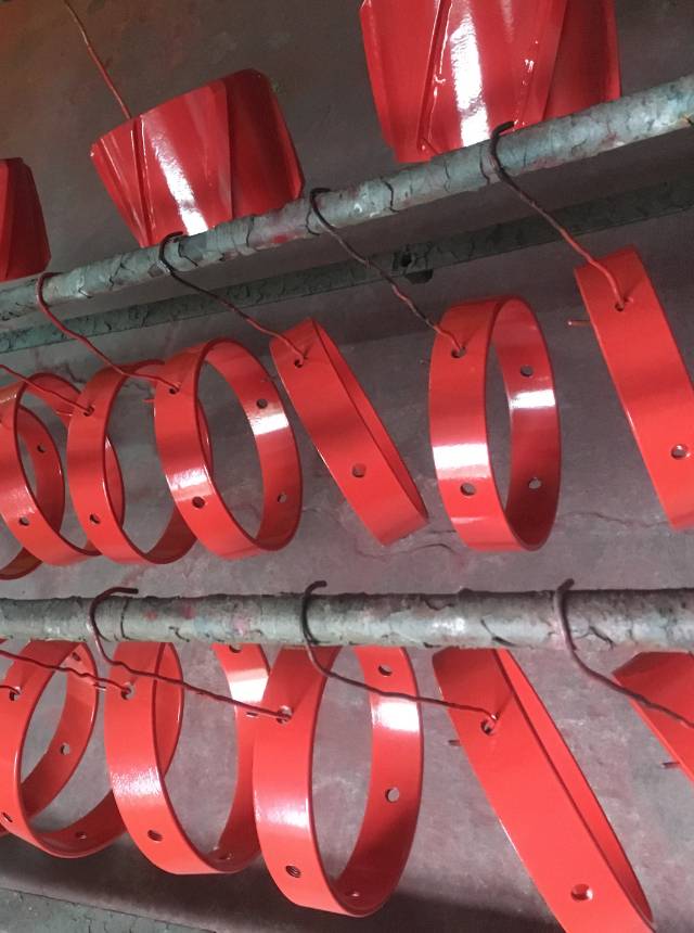 Several stop collars are powder coated with red powders.