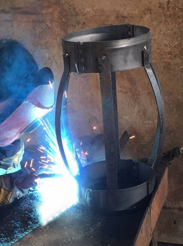 A worker is welding the strips on the end color.